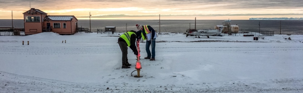 Two WASCO employees inspect the airfield lighting at the remote northern airport.