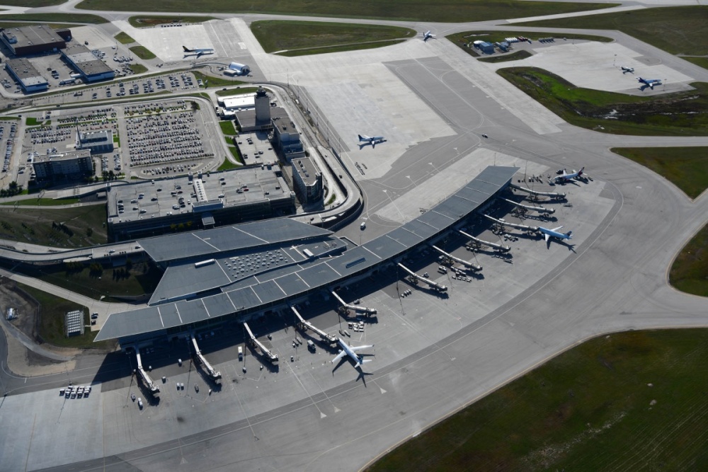 Aerial view of Winnipeg Richardson International Airport and airfield with planes at gates.